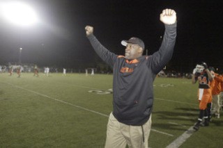 Central Kitsap coach Mark Keel celebrates as the clock expires during CK's 21-6 win against Rogers of Puyallup at Silverdale Stadium Saturday night. With the win