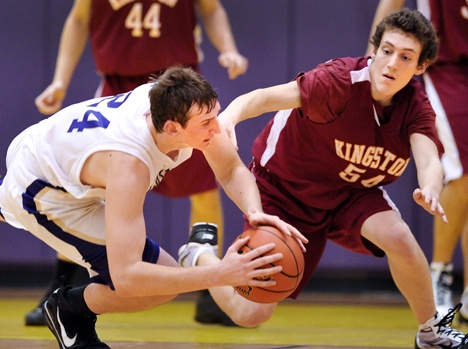 North Kitsap player Brandyn Winkley dives for the ball before Kingston's Ryan Byers can get the steal during a fast action game at North Kitsap Friday night. Kingston beat North 49-42.