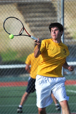 Varsity tennis player Zach Fohn during a singles match against Sequim on Wednesday