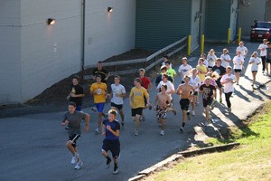 The Viking's cross country team runs behind North Kitsap High School during their last practice on Wednesday