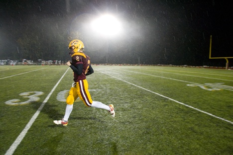 Kingston Buccaneers' Quarterback Tucker Bowman warms up before taking the field against the Klahowya Eagles in their first night game under the newly installed lights at Buccaneer Stadium in Kingston WA. Friday