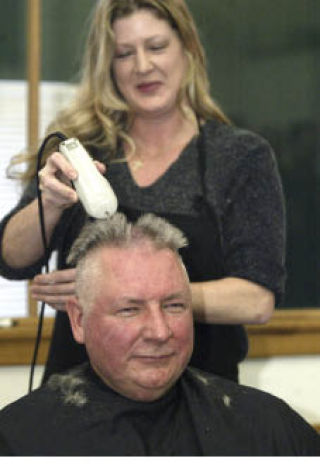 Washington State Patrol Sergeant Ken Przygocki got his head shaved by Heidi Bayly of Indigo Salon in Bremerton. He was one of many law enforcement officers who shaved their heads Monday in support of 13-year-old Ashley Mjor who is battling Type B non-Hodgkin’s lymphoma.