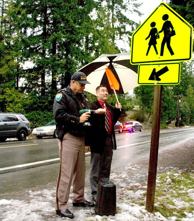 Kitsap County Sheriff Steve Boyer and Central Kitsap School District Superintendent Greg Lynch prepare to install a small garbage can