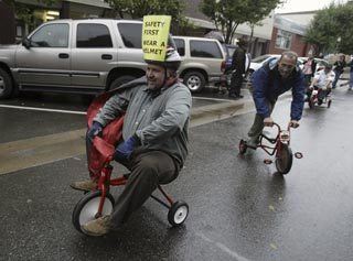 Kitsap County Health District Director Dr. Scott Lindquist passes Steve Rice of Rice Fergus Miller Architecture and Planning while racing down Fourth Street in the Bremerton Trike Race Oct. 3. The second annual event benefited United Way of Kitsap County.