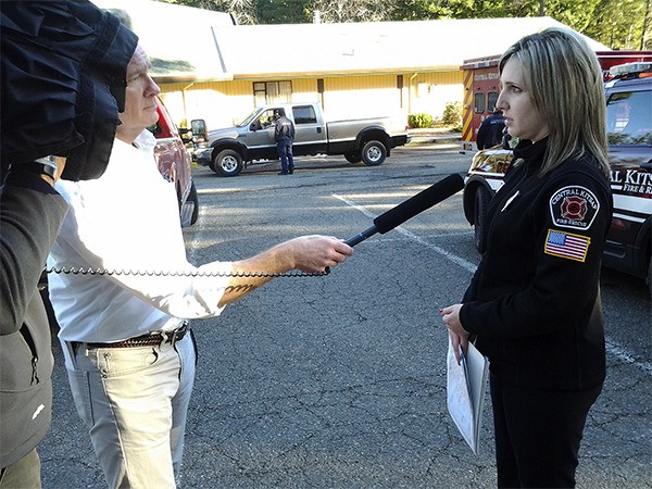 Central Kitsap Fire & Rescue public information officer Ileana LiMarzi briefs KIRO 7 reporter Kevin McCarty on efforts to locate a plane that reportedly crashed in Hood Canal near Seabeck