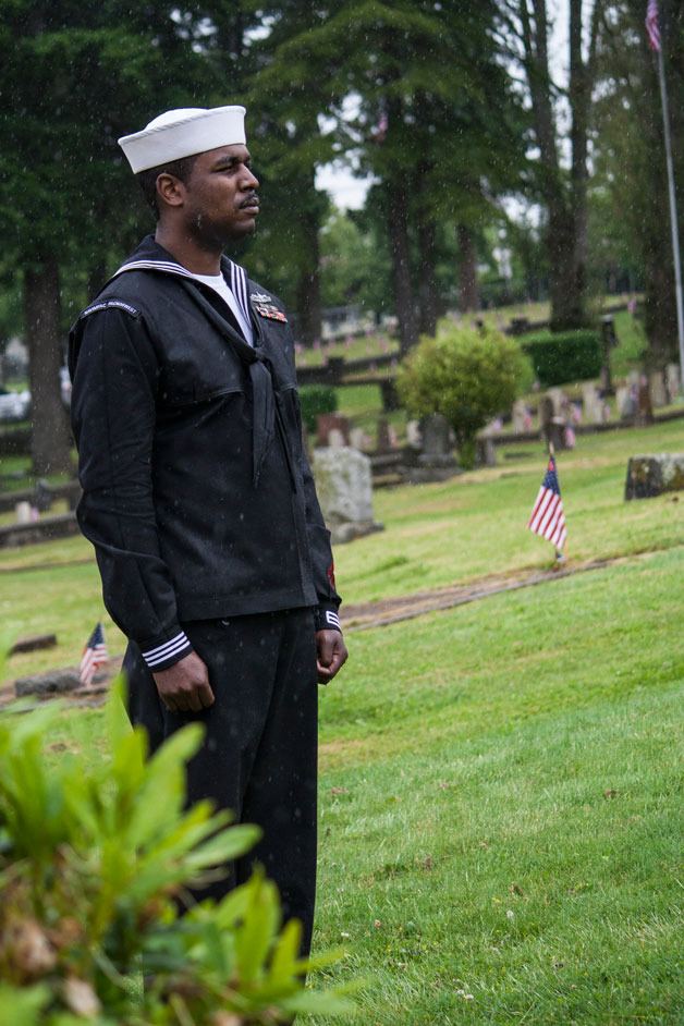 MM1 Jason Smith stands at attention through the entirety of the ceremony at Ivy Green Cemetery in Bremerton on Monday.