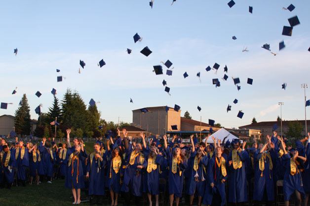 Some 292 Bremerton High School students toss their caps into the air during the school’s 35th commencement ceremony. This year’s class had the highest graduation rate in the school’s history.