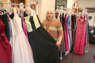 Diane Potts of the Community Transitions Program shows one of the dresses donated to the Prom Closet