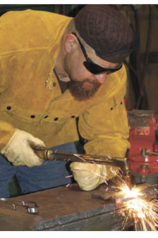 Olympic College welding student Rich Kruzner takes a welding exam at the college May 5.