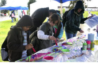 Kitsap County fourth-graders painted dead fish to make fish prints Tuesday at the Kitsap Water Festival at the Fairgrounds. More than 1