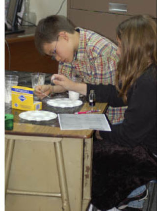 Students at Sylvan Way Christian Schools examine “evidence” they collected while investigating a case during the school’s first-ever Mystery Science week.