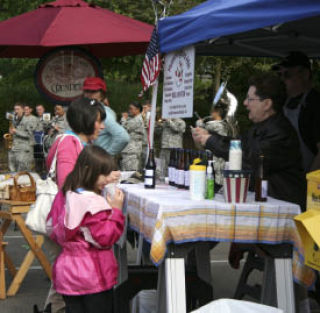 Dee Armstrong (right) sells Hummingbird Hill homemade soda to customers at the Bremerton Farmers Market May 14. The farmers market is now located in the south parking lot of Evergreen Park.