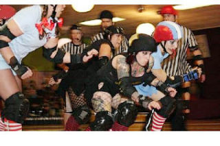 Slaughter County Roller Vixens — Darth Maul Her (second from right) of the Death Rattle Rollers and A. Cup Killer (right) of the Terrormedixxx face off in a recent bout. See SCRV take on the Rat City Rollergirls Sunday in Bremerton.