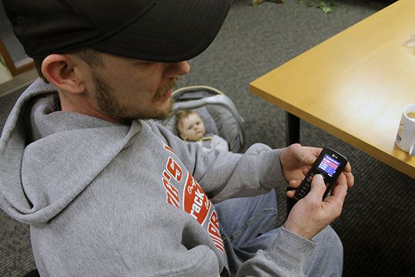 Ash Daignault reviews his call list showing how many times he unsuccessfully called 911 on his cell phone. Looking on is Ally Mae