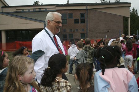 Kitsap Lake Principal Flint Walpole laughs with third graders during recess. Walpole is ending his 22-year career in the Bremerton School District after this school year.