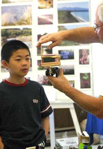 Brad Griffith shows off some of his unique pinewood derby cars last year at the inaugural Kitsap MiniMaker Faire.