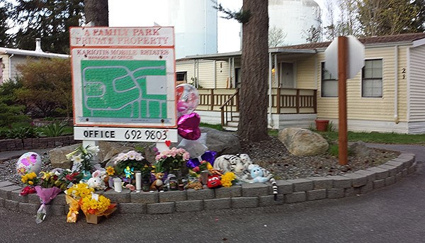 Flowers and stuffed animals were placed near the mobile home where two people were killed March 28.