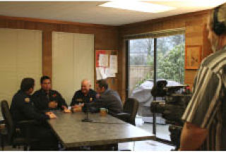 Bremerton firefighters play cards and swap stories Monday afternoon while local producer/director Rick Foxworth films them. Foxworth is making a film about the Bremerton Fire Department and