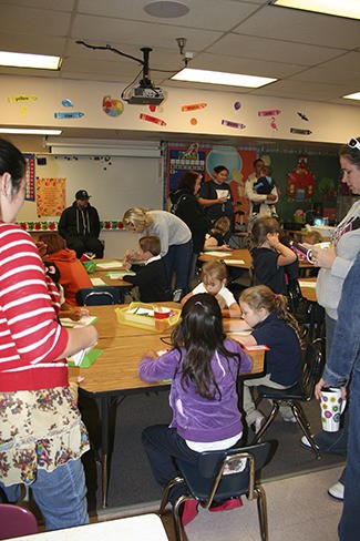 Kindergarten students settle in to color on the first day of school at West Hills S.T.E.M. Academy.