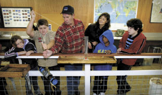 Lab director Ralph St. Andre works with students performing a salinity test at the Poulsbo Marine Science Center. Suquamish students were visiting and running the gamut of experiments in the new floating lab facility.  Pictured (left to right) are Trenna McDaniel