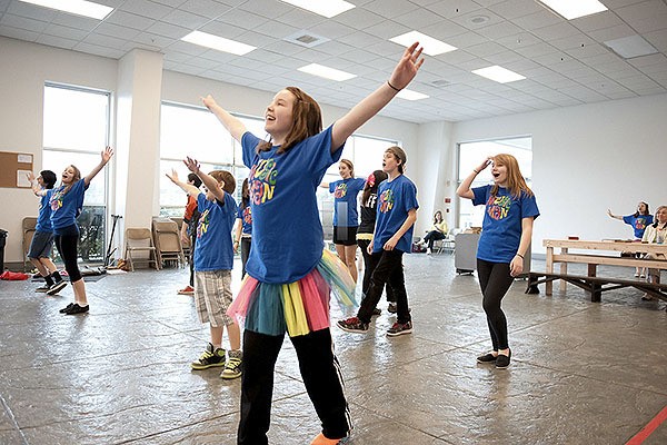 Cast members rehearse a song from 'The Music Man' in May 2012 in the former Chevy dealership on Viking Avenue. Kitsap Children's Musical Theatre later moved to the former Courtesy Ford site next door. KCMT is now negotiating a long-term lease with the North Kitsap School District for use of the now-closed Breidablik Elementary School.