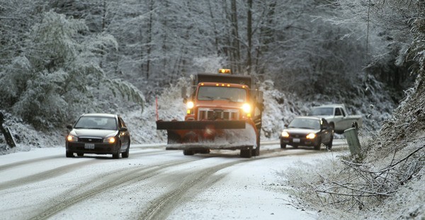 County crews were busy keeping roads clear as the first snow of the year swept across North Kitsap late Sunday. This photo was taken on Gunderson Road.