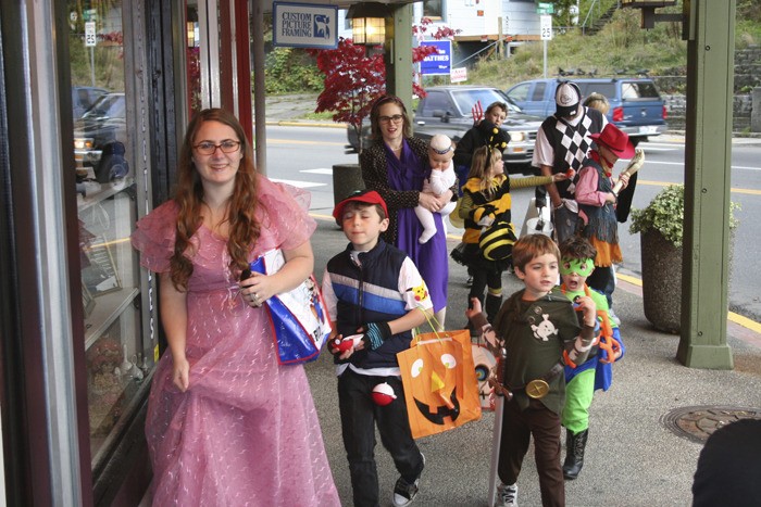 Trick-or-treaters visited Bay Street merchants on Monday.