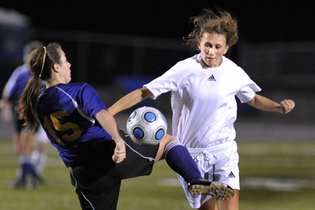 North Kitsap High senior Madi Taylor charges a Sequim defender Tuesday in the Vikings' 10-0 win at the NK Stadium.