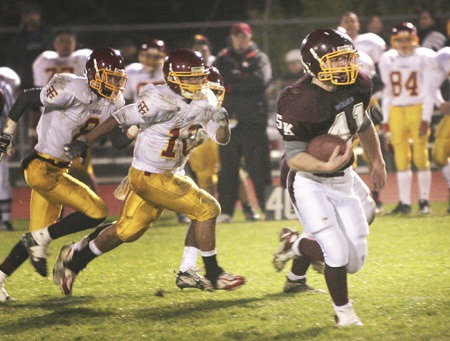 South Kitsap running back J.C. Parker leaves a trail of Mount Tahoma defenders in his wake during the Wolves’ 54-18 win on Thursday to cap off the team’s first unbeaten season since 2002.