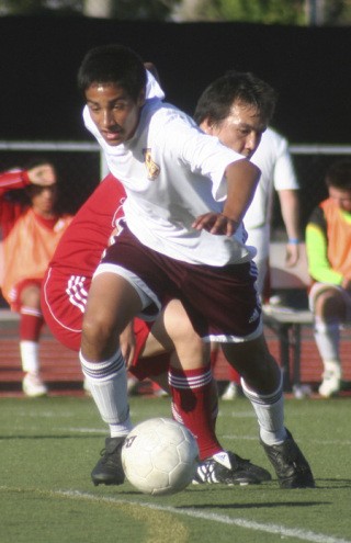 South Kitsap’s Nico de la Cruz maneuvers around a Marysville-Pilchuck defender in the Wolves’ 5-3 win in the Washington State 4A soccer tournament on Friday night in Lakewood.