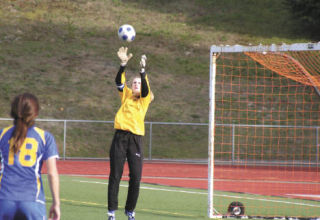 BHS senior goalkeeper Kristy Wood soars for a save during the Lady Knights’ 2-0 loss to Olympic at Silverdale Stadium Tuesday. BHS wraps up the regular season Tuesday against undefeated North Kitsap