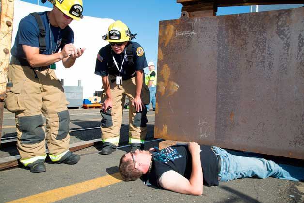 Navy Region Northwest Fire and Emergency Services personnel assist PSNS & IMF employee Kevin Albert