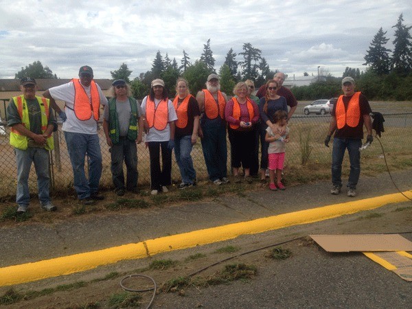 A dozen volunteers clean and paint school-zone curbs Saturday in Bremerton.