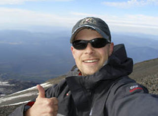 Chris Henrickson gives a thumbs up during his climb of Mount Adams Aug. 28 and 29 to benefit the Harrison Foundation. So far