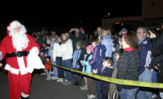 Santa Claus is greeted by the community upon his arrival at last year’s Silverdale Christmas tree lighting ceremony.