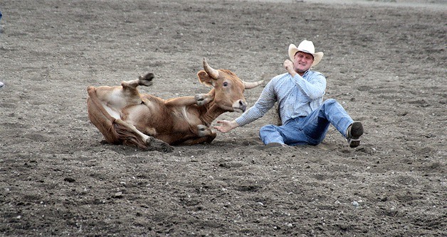 A cowboy misses his mark in the steer wrestling competition during the rodeo at the Kitsap County Fairgrounds Saturday