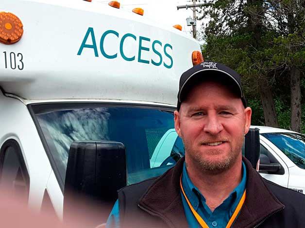 Robert Floyd stands in front of his Kitsap ACCESS bus. Floyd placed second among Washington drivers