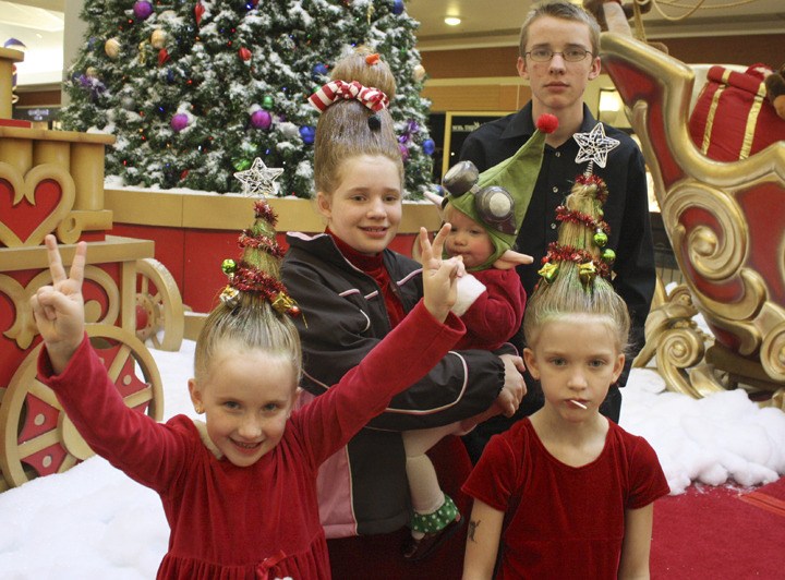 The Montieth siblings gather after having their picture taken with Santa at Kitsap Mall last week. Their hair drew comments and compliments from all quarters.