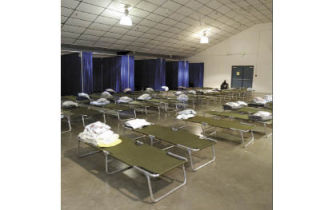 Rows of beds line the inside of the weather shelter set up at the President’s Hall at the Kitsap County Fairgrounds.