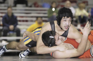 Bremerton’s Andres Garcia holds an A.C. Davis opponent in a headlock during the opening round of last Saturday’s Olympic Dream Duals at the Kitsap Fairgrounds Pavilion. Garcia wrestled at 215 pounds.