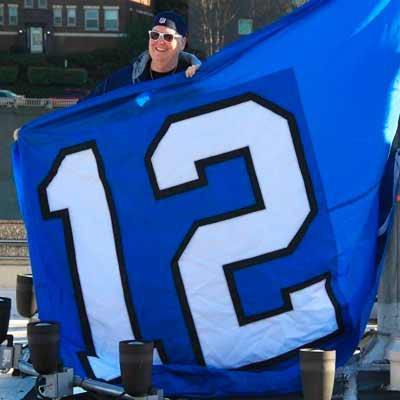 Big Lo holding the 12th Man flag.