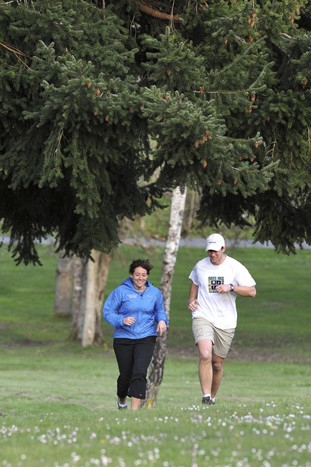 Debbee and John Straub take a jog in Kingston on Wednesday. The Straubs are helping to organize Kitsap's first 100-mile ultramarathon