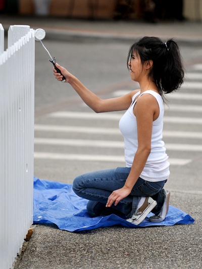 Courtney Hood spent part of Wednesday whitewashing a new picket fence along Front Street. The fence is at the corner of Jensen and Front streets.