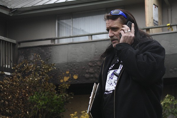 Madrona Estates Apartments Manager Rick Lott stands in front of the burnt out remains of his old second-floor apartment and the unit directly below his in which Dora M. Crockett