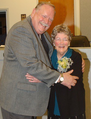 Councilman John Clauson hugs Carolyn Powers during her retirement ceremony on Dec. 10 at City Hall.