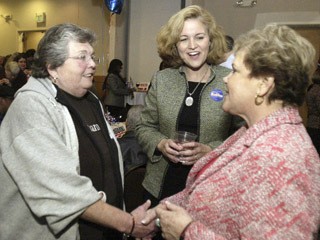 Nancy Nystrom (left) from Bremerton shakes hands with Sherry Appleton and chats with Christine Rolfes (center) during the Democratic election party at the Silverdale Beach Hotel Tuesday night.