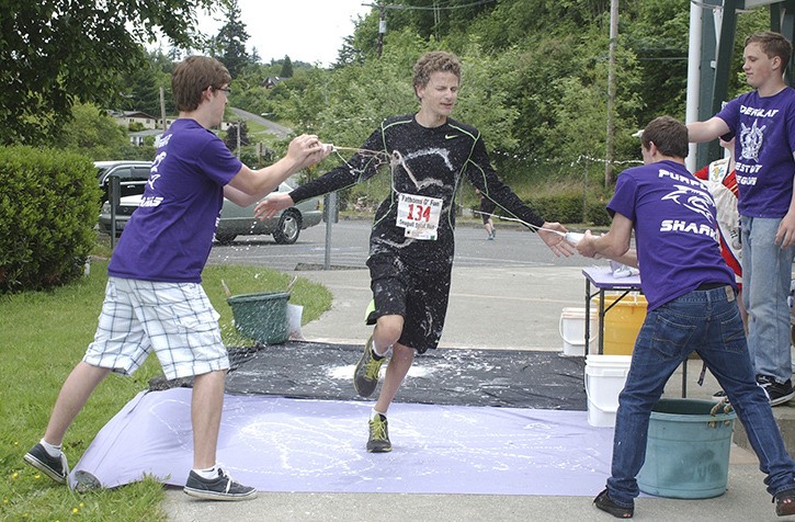 Connor Morris runs through a “splat station” during the first half of last year’s Seagull Splat 5K Run.