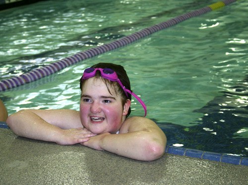 Karissa Parypa of the North Kitsap Vikings Special Olympics Swimming Team takes a breather during practice Tuesday at the North Kitsap Community Pool. Fifteen athletes from the team will compete at the state Special Olympics Swimming Championships June 5-6 in Federal Way.