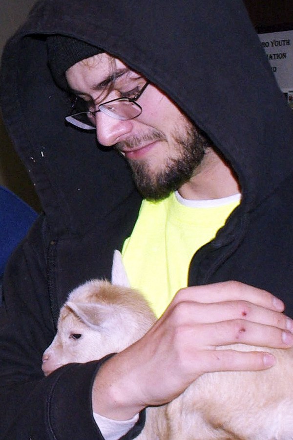 Gabriel Martin bonds with a doeling during a visit at Coffee Oasis.