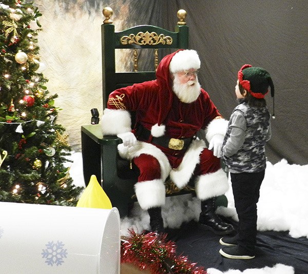 Santa Claus listens intently to a young child’s wish list for Christmas. Jolly Ol’ St. Nick was the guest of honor at the “Breakfast with Santa” event Nov. 28 at the Port Orchard Eagles.